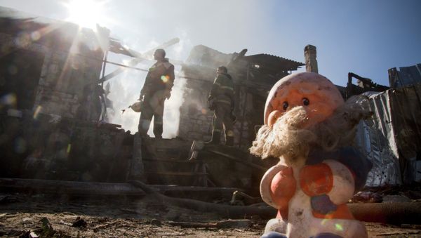 Firefighters inspect a burned house after shelling in the town of Donetsk, eastern Ukraine, Firefighters inspect a burned house after shelling in the town of Donetsk, eastern Ukraine, - Sputnik International