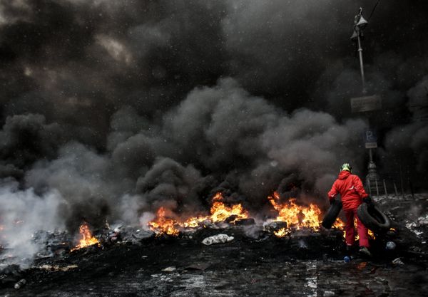 A protester adds tire to the fire in Maidan square in Kiev, Ukraine, Jan 22, 2014 A protester adds tire to the fire in Maidan square in Kiev, Ukraine, Jan 22, 2014 - Sputnik International