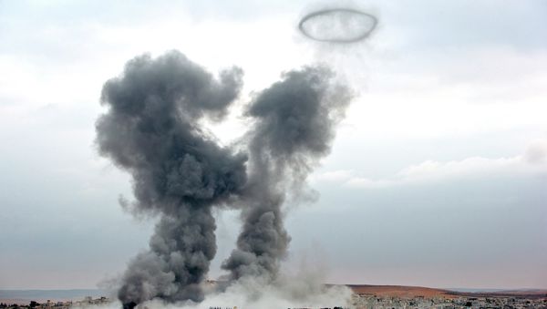 Smoke rises from the Syrian city of Kobani, following airstrikes by the US led coalition, seen from a hilltop outside Suruc, on the Turkey-Syria border Monday, Nov. 17, 2014 - Sputnik International
