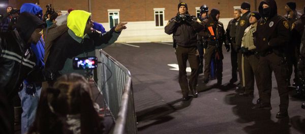 Protesters shout towards police as they demand the criminal indictment of a white police officer who shot dead an unarmed black teenager in August, outside the Ferguson Police Station in Missouri November 20, 2014 Protesters shout towards police as they demand the criminal indictment of a white police officer who shot dead an unarmed black teenager in August, outside the Ferguson Police Station in Missouri November 20, 2014 - Sputnik International
