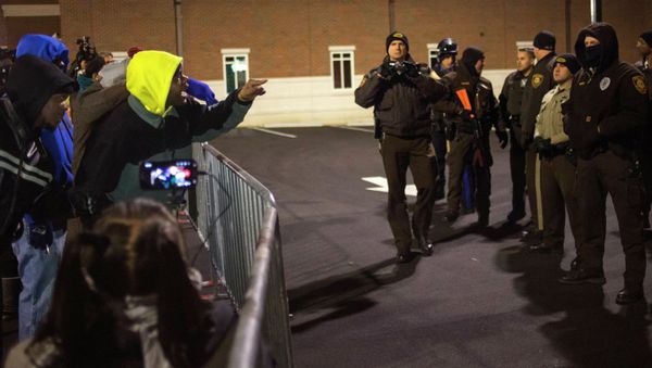 Protesters shout towards police as they demand the criminal indictment of a white police officer who shot dead an unarmed black teenager in August, outside the Ferguson Police Station in Missouri November 20, 2014 - Sputnik International