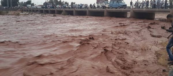 This image taken with a mobile phone shows residents of Guelmim, south western Morocco, crossing a bridge over floodwaters This image taken with a mobile phone shows residents of Guelmim, south western Morocco, crossing a bridge over floodwaters - Sputnik International