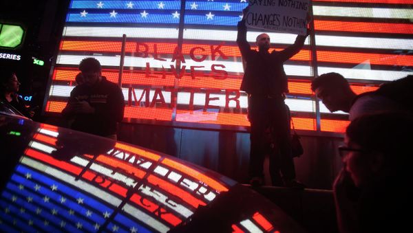 Protesters demonstrate in Times Square after the grand jury's decision to not charge Ferguson police officer Darren Wilson in the shooting death of unarmed 18-year-old Michael Brown was announced, in New York - Sputnik International