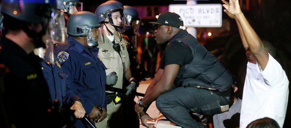 A protester faces off against a line of police on the 110 freeway during a demonstration in Los Angeles, California following the grand jury decision in the shooting of Michael Brown in Ferguson A protester faces off against a line of police on the 110 freeway during a demonstration in Los Angeles, California following the grand jury decision in the shooting of Michael Brown in Ferguson - Sputnik International