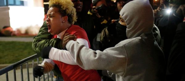 A woman approaches the barricade to confront the police outside the Ferguson Police Department in Ferguson, Missouri A woman approaches the barricade to confront the police outside the Ferguson Police Department in Ferguson, Missouri - Sputnik International