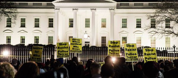 Protesters demonstrate after the decision by a Missouri grand jury not to indict a white Ferguson police officer in the fatal shooting of unarmed black teenager Michael Brown, in front of the White House in Washington Protesters demonstrate after the decision by a Missouri grand jury not to indict a white Ferguson police officer in the fatal shooting of unarmed black teenager Michael Brown, in front of the White House in Washington - Sputnik International
