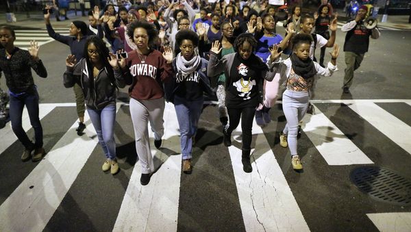 Hundreds of protesters chanted and carried signs through the streets of Washington, DC, Tuesday night to show solidarity with Michael Brown, a black teenager shot dead by a police officer in Ferguson in August and other victims of police violence. Hundreds of protesters chanted and carried signs through the streets of Washington, DC, Tuesday night to show solidarity with Michael Brown, a black teenager shot dead by a police officer in Ferguson in August and other victims of police violence. - Sputnik International
