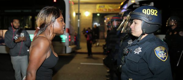 Amanda Ashe of Oakland, left, faces off with a police officer during the second night of demonstrations in Emeryville, California, following the grand jury decision in the shooting of Michael Brown in Ferguson, Missouri Amanda Ashe of Oakland, left, faces off with a police officer during the second night of demonstrations in Emeryville, California, following the grand jury decision in the shooting of Michael Brown in Ferguson, Missouri - Sputnik International