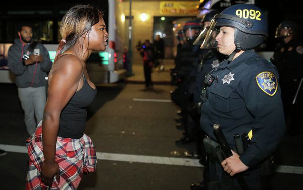 Amanda Ashe of Oakland, left, faces off with a police officer during the second night of demonstrations in Emeryville, California, following the grand jury decision in the shooting of Michael Brown in Ferguson, Missouri Amanda Ashe of Oakland, left, faces off with a police officer during the second night of demonstrations in Emeryville, California, following the grand jury decision in the shooting of Michael Brown in Ferguson, Missouri - Sputnik International