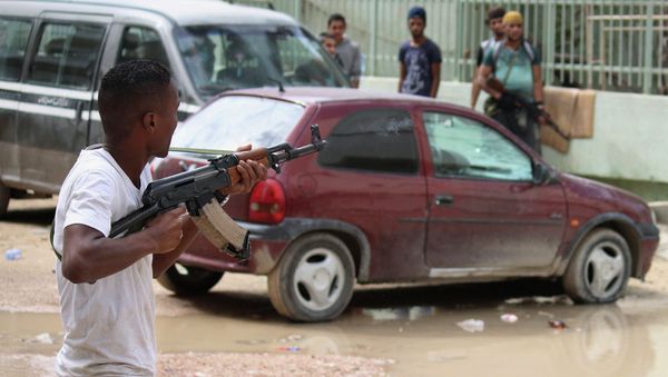 A man with an armed group of Libyan people holds a weapon to defend their local area from Islamic militias in Benghazi, Libya, Thursday, Oct. 23, 2014 A man with an armed group of Libyan people holds a weapon to defend their local area from Islamic militias in Benghazi, Libya, Thursday, Oct. 23, 2014 - Sputnik International