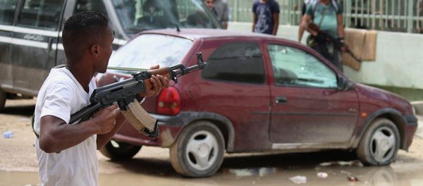 A man with an armed group of Libyan people holds a weapon to defend their local area from Islamic militias in Benghazi, Libya, Thursday, Oct. 23, 2014 A man with an armed group of Libyan people holds a weapon to defend their local area from Islamic militias in Benghazi, Libya, Thursday, Oct. 23, 2014 - Sputnik International