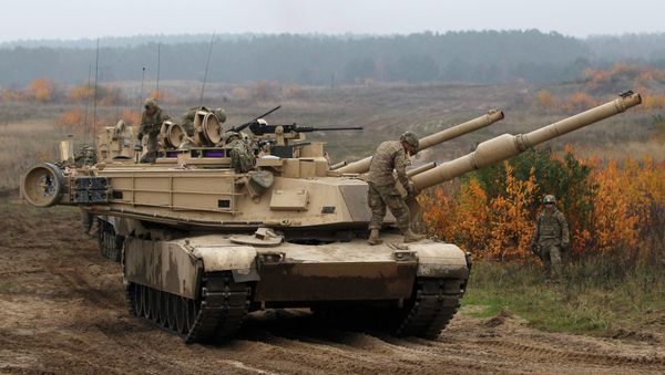 Members of the U.S. 1st Brigade Combat Team, 1st Cavalry Division disembark from an Abrams tank during a military exercise with Poland's 1st Mechanized Battalion of the 7th Coastal Defence Brigade near Drawsko-Pomorskie November 13, 2014 Members of the U.S. 1st Brigade Combat Team, 1st Cavalry Division disembark from an Abrams tank during a military exercise with Poland's 1st Mechanized Battalion of the 7th Coastal Defence Brigade near Drawsko-Pomorskie November 13, 2014 - Sputnik International