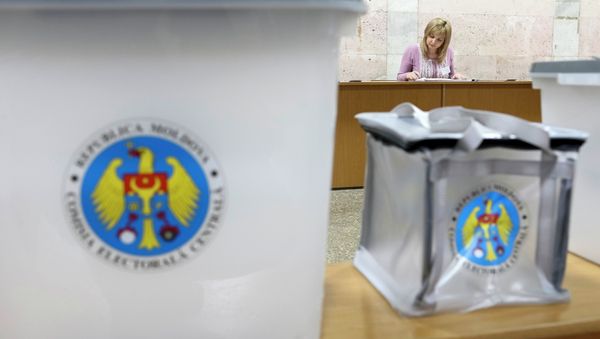 Ballot boxes are seen as a member of a local electoral commission works with papers at a polling station in Chisinau November 29, 2014 Ballot boxes are seen as a member of a local electoral commission works with papers at a polling station in Chisinau November 29, 2014 - Sputnik International