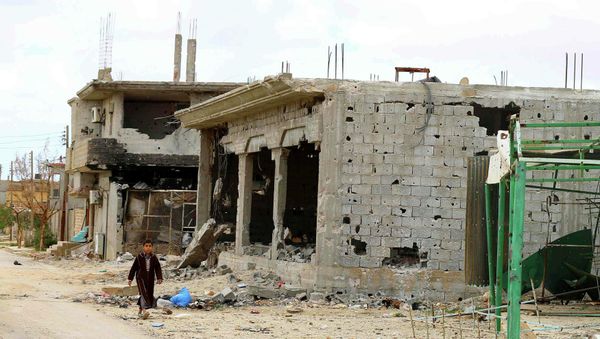 A boy walks next to the ruins of buildings in Benina, about 20 km east of Benghazi, November 21, 2014 - Sputnik International