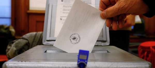 A man casts his voting ballot at the polling station in the Spitalacker school in Bern November 29, 2014 A man casts his voting ballot at the polling station in the Spitalacker school in Bern November 29, 2014 - Sputnik International