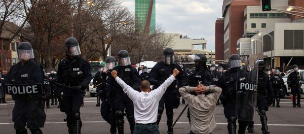 Protesters demanding justice for Michael Brown kneel on the ground before they are detained for disrupting traffic outside the Edward Jones Dome, the site of an NFL football game between the St. Louis Rams and the Oakland Raiders, in downtown St. Louis Protesters demanding justice for Michael Brown kneel on the ground before they are detained for disrupting traffic outside the Edward Jones Dome, the site of an NFL football game between the St. Louis Rams and the Oakland Raiders, in downtown St. Louis - Sputnik International