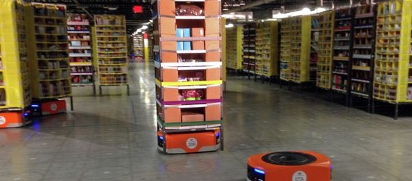 A Kiva robot drive unit is seen, foreground, before it moves under a stack of merchandise pods, seen on a tour of one of Amazon's newest distribution centers in Tracy A Kiva robot drive unit is seen, foreground, before it moves under a stack of merchandise pods, seen on a tour of one of Amazon's newest distribution centers in Tracy - Sputnik International