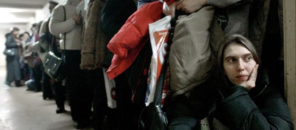 In this image dated Jan.28, 2004, showing a Romanian woman as she leans against the door at the International Office for Migration in Bucharest, Romania, Jan. 28, 2004, waiting in a line to apply for a job in Spain In this image dated Jan.28, 2004, showing a Romanian woman as she leans against the door at the International Office for Migration in Bucharest, Romania, Jan. 28, 2004, waiting in a line to apply for a job in Spain - Sputnik International