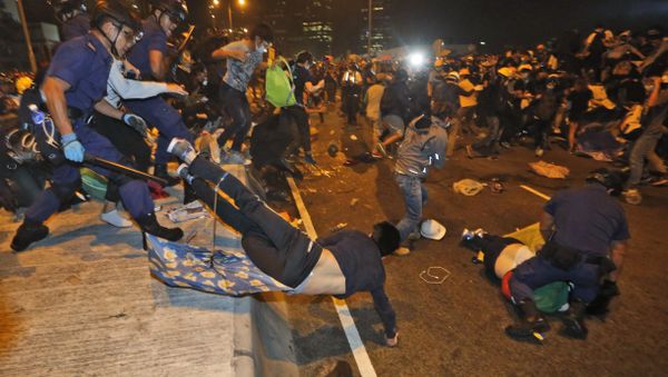 Police officers throw a pro-democracy protester on the main road outside government headquarters in Hong Kong Police officers throw a pro-democracy protester on the main road outside government headquarters in Hong Kong - Sputnik International