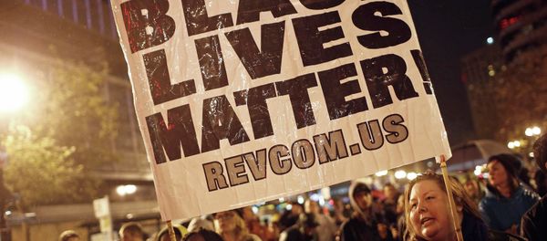 Protesters hold a sign during a march against the New York City grand jury decision to not indict in the death of Eric Garner, in Oakland, California December 3, 2014. - Sputnik International