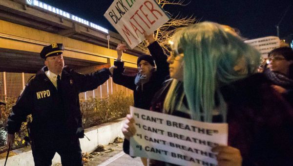 A policeman grabs a protester, who was demanding justice for the death of Eric Garner, as he was marching along the West Side Highway in Manhattan, New York December 3, 2014. - Sputnik International