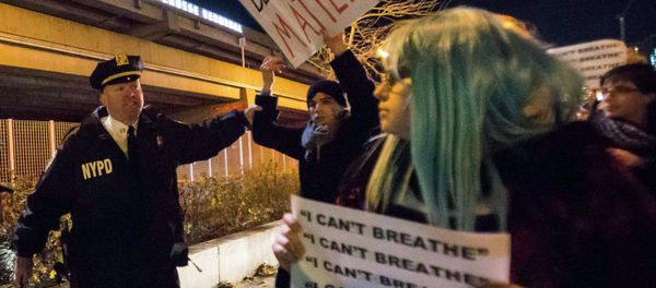 A policeman grabs a protester, who was demanding justice for the death of Eric Garner, as he was marching along the West Side Highway in Manhattan, New York December 3, 2014. - Sputnik International