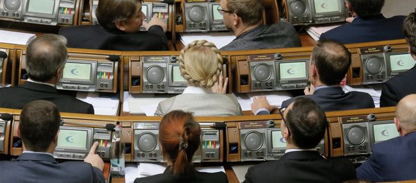 Former Prime Minister and leader of the Fatherland party Yulia Tymoshenko, center, and lawmakers from her party vote during a parliament session in Kiev, Ukraine, Tuesday, Dec. 2, 2014 - Sputnik International