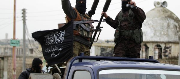 Members of al Qaeda's Nusra Front gesture as they drive in a convoy touring villages, which they said they have seized control of from Syrian rebel factions, in the southern countryside of Idlib, December 2, 2014 - Sputnik International