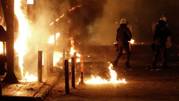 Riot police try to avoid petrol bombs thrown by protesters during clashes in the Athens neighborhood of Exarchia, a haven for extreme leftists and anarchists, on Saturday, Dec. 6, 2014 - Sputnik International