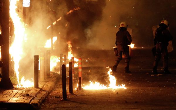 Riot police try to avoid petrol bombs thrown by protesters during clashes in the Athens neighborhood of Exarchia, a haven for extreme leftists and anarchists, on Saturday, Dec. 6, 2014 Riot police try to avoid petrol bombs thrown by protesters during clashes in the Athens neighborhood of Exarchia, a haven for extreme leftists and anarchists, on Saturday, Dec. 6, 2014 - Sputnik International