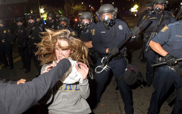 A protester flees as police officers try to disperse a crowd comprised largely of student demonstrators during a protest against police violence in the U.S., in Berkeley, California early December 7, 2014 A protester flees as police officers try to disperse a crowd comprised largely of student demonstrators during a protest against police violence in the U.S., in Berkeley, California early December 7, 2014 - Sputnik International