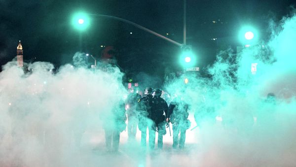 Police officers deploy teargas while trying to disperse a crowd comprised largely of student protesters during a protest against police violence in the U.S., in Berkeley, California early December 7, 2014 Police officers deploy teargas while trying to disperse a crowd comprised largely of student protesters during a protest against police violence in the U.S., in Berkeley, California early December 7, 2014 - Sputnik International