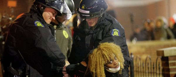 Police officers take a protester into custody Tuesday, Nov. 25, 2014, in Ferguson Police officers take a protester into custody Tuesday, Nov. 25, 2014, in Ferguson - Sputnik International