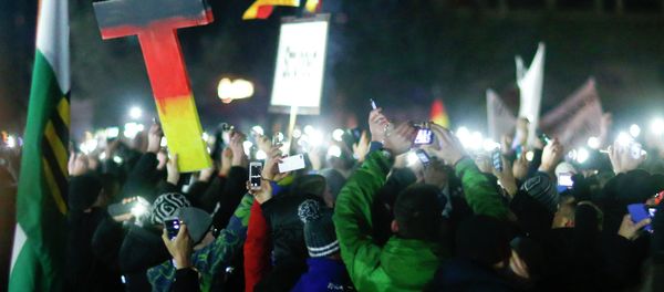 Participants hold up their mobile phones during a demonstration called by anti-immigration group PEGIDA, a German abbreviation for Patriotic Europeans against the Islamization of the West, in Dresden December 8, 2014. - Sputnik International