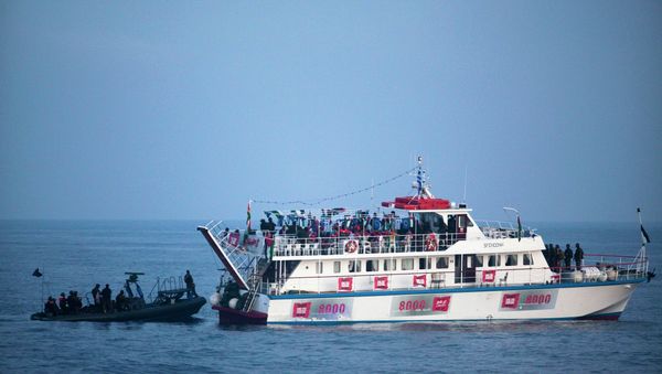 Image reviewed by the Israeli military and taken aboard an Israeli Naval vessel, Israeli Navy soldiers intercept one of several boats headed towards the Gaza Strip, in international waters in the Mediterranean Sea - Sputnik International