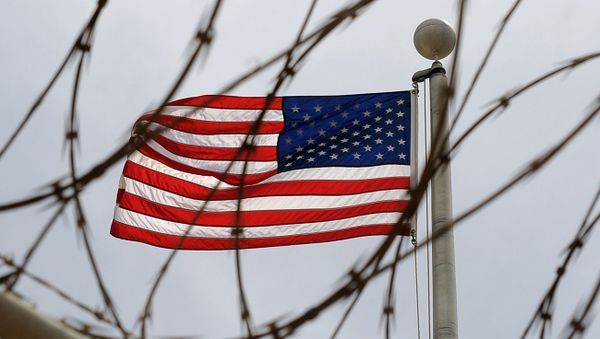 An American Flag is seen through razor wire at Camp VI in Camp Delta where detainees are housed at Naval Station Guantanamo Bay in Cuba An American Flag is seen through razor wire at Camp VI in Camp Delta where detainees are housed at Naval Station Guantanamo Bay in Cuba - Sputnik International