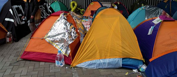 A protester walks past tents outside the government headquarters at Admiralty in Hong Kong December 10, 2014. - Sputnik International