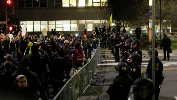 Protesters chant in front of a police line outside Berkley Police Department headquarters during a march against the New York City grand jury decision to not indict in the death of Eric Garner in Berkeley, California December 9, 2014. Protesters chant in front of a police line outside Berkley Police Department headquarters during a march against the New York City grand jury decision to not indict in the death of Eric Garner in Berkeley, California December 9, 2014. - Sputnik International
