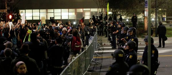 Protesters chant in front of a police line outside Berkley Police Department headquarters during a march against the New York City grand jury decision to not indict in the death of Eric Garner in Berkeley, California December 9, 2014. Protesters chant in front of a police line outside Berkley Police Department headquarters during a march against the New York City grand jury decision to not indict in the death of Eric Garner in Berkeley, California December 9, 2014. - Sputnik International