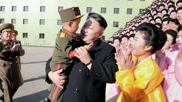 North Korean leader Kim Jong Un holds a boy after a photo session with participants in the Second Meeting of KPA Exemplary Servicemen's Families in this undated photo released by North Korea's Korean Central News Agency (KCNA) in Pyongyang North Korean leader Kim Jong Un holds a boy after a photo session with participants in the Second Meeting of KPA Exemplary Servicemen's Families in this undated photo released by North Korea's Korean Central News Agency (KCNA) in Pyongyang - Sputnik International