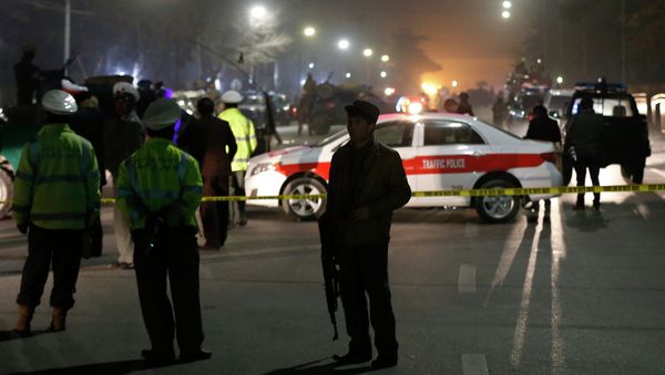 Afghan policemen stand guard at the site of a suicide attack in Kabul - Sputnik International