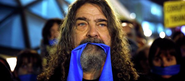 A demonstrator takes part in a mock funeral during a protest against the Spanish government's new security law at Madrid's landmark Puerta del Sol. A demonstrator takes part in a mock funeral during a protest against the Spanish government's new security law at Madrid's landmark Puerta del Sol. - Sputnik International