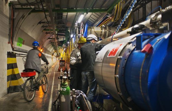 An engineer on a bicycle provided for tunnel transportation rides past engineers working on the Large Hadron collider in the 27Km circular tunnel at CERN near Geneva in the planned 2013 shutdown An engineer on a bicycle provided for tunnel transportation rides past engineers working on the Large Hadron collider in the 27Km circular tunnel at CERN near Geneva in the planned 2013 shutdown - Sputnik International