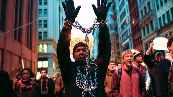 A man with a chain on his body takes part in a march against police violence, in New York December 13, 2014 A man with a chain on his body takes part in a march against police violence, in New York December 13, 2014 - Sputnik International
