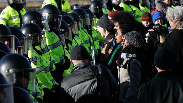 Demonstrators face a line of police officers during a demonstration against recent grand jury decisions not to indict police officers in the deaths of Michael Brown and Eric Garner, in Boston, Massachusetts December 13, 2014 Demonstrators face a line of police officers during a demonstration against recent grand jury decisions not to indict police officers in the deaths of Michael Brown and Eric Garner, in Boston, Massachusetts December 13, 2014 - Sputnik International