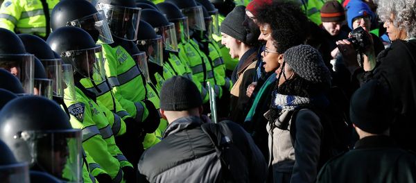 Demonstrators face a line of police officers during a demonstration against recent grand jury decisions not to indict police officers in the deaths of Michael Brown and Eric Garner, in Boston, Massachusetts December 13, 2014 Demonstrators face a line of police officers during a demonstration against recent grand jury decisions not to indict police officers in the deaths of Michael Brown and Eric Garner, in Boston, Massachusetts December 13, 2014 - Sputnik International