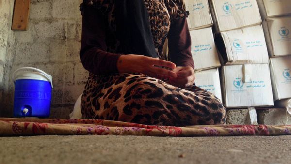 In this photo taken on October 8, 2014, a 15-year-old Yazidi girl captured by the Islamic State group and forcibly married to a militant in Syria. - Sputnik International