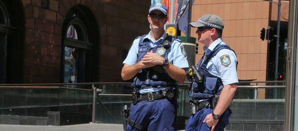 Police stand near a police line to stop pedestrian access close to a cafe under siege at Martin Place in Sydney, Australia, Monday, Dec. 15, 2014 Police stand near a police line to stop pedestrian access close to a cafe under siege at Martin Place in Sydney, Australia, Monday, Dec. 15, 2014 - Sputnik International