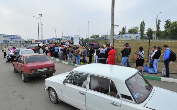 Ukrainian refugees line up to return to their homes in eastern Ukraine at the Russia-Ukraine border  - Sputnik International