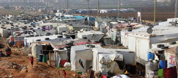 Syrian refugees walk at a refugee camp in Zahle in the Bekaa valley November 18, 2014 Syrian refugees walk at a refugee camp in Zahle in the Bekaa valley November 18, 2014 - Sputnik International